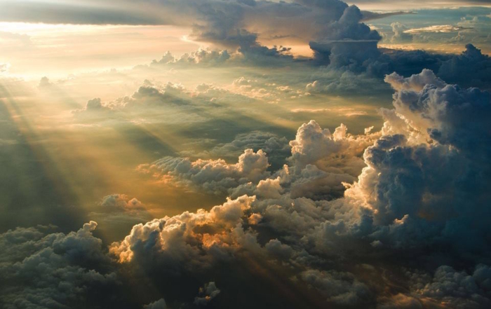 Soft light breaking through clouds symbolizing awe in uncertain times